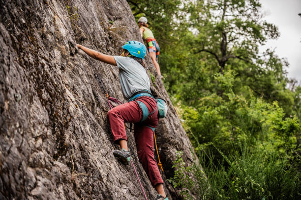 istock Female climber climbing mountain 1985661574