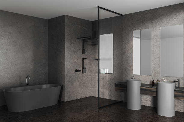 istock Grey home bathroom interior with shower, bathtub and sink with accessories 1985680909