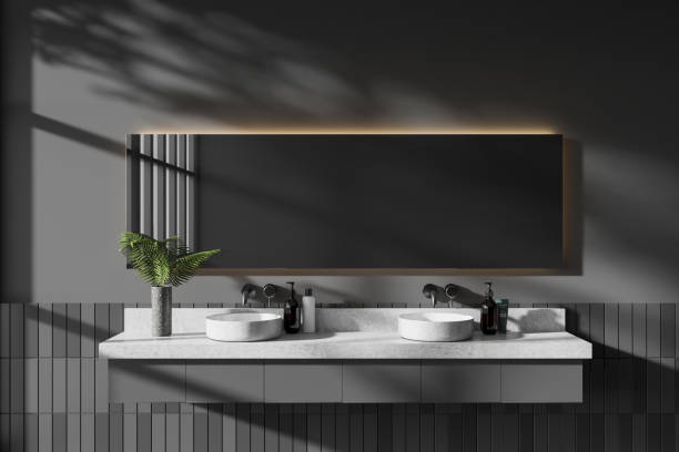 istock Grey hotel bathroom interior with double sink and minimalist accessories 1985684040