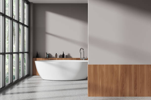 istock Cozy bathroom interior with bathtub, shelf with accessories and mockup wall 1985687200