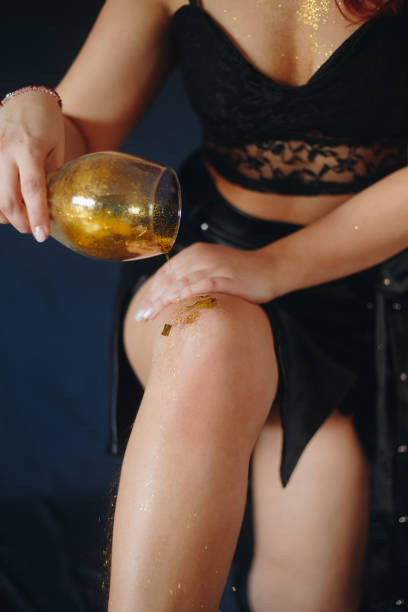 Female legs covered with glitter stock photo