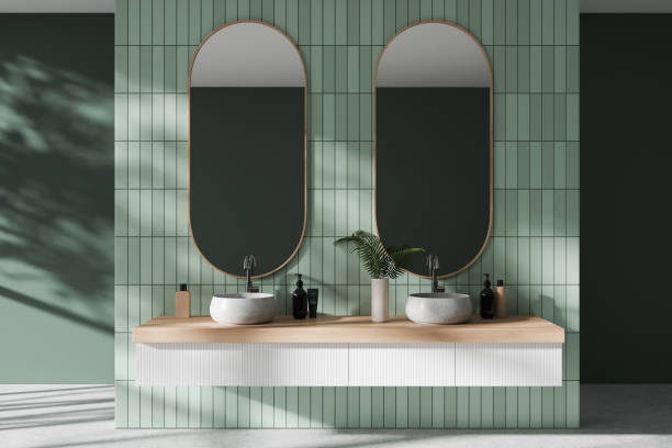 istock Green stylish hotel bathroom interior with double sink and accessories 1985696017