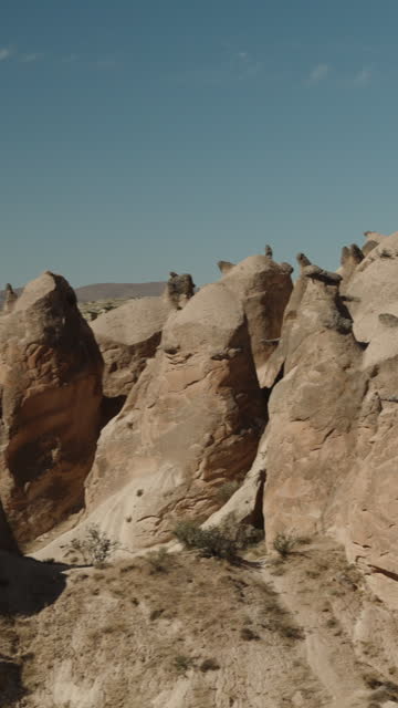 Vertical video. A panorama of the hill formations resembling towers in the Valley of Imaginations in Turkey.