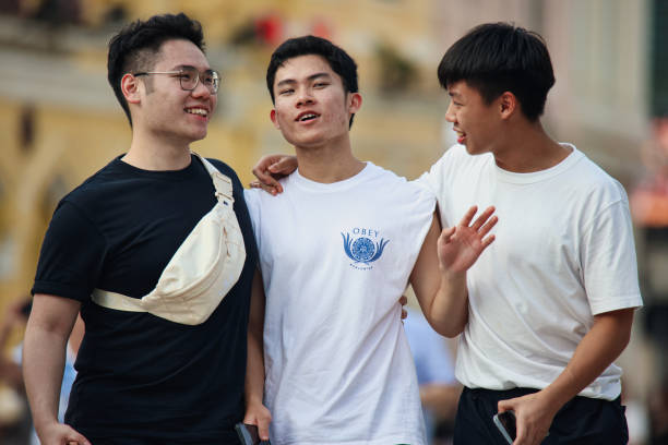 Macao, China - May 12, 2023: Three men stand side by side in a street in Macao, their presence creating a sense of camaraderie and unity.