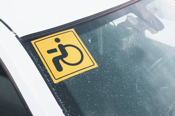 istock A sticker on the windshield of a car warning that the driver is a disabled driver with disabilities. 1985760396