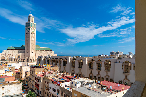 An image showcasing the Mausoleum of Mohammed V and the nearby Unfinished Mosque in Rabat, Morocco. This site combines solemn reverence and historical intrigue, featuring intricate Islamic architecture and a significant legacy in Moroccan history.