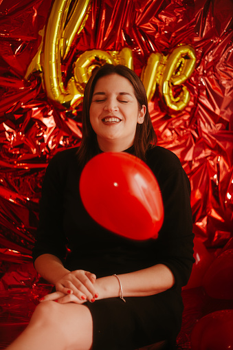 Happy woman with love inscription balloon stock photo