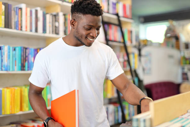 istock A cheerful student in a library, surrounded by books, actively engaging in academic pursuits and education. 1985779876