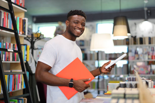 istock Happy young African American student in a modern indoor setting, confidently engaged in education and learning. 1985779878