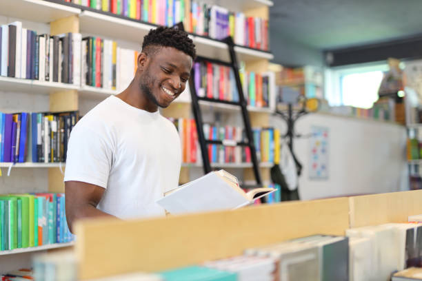 istock A serious young man in a library, engaged in academic pursuits, surrounded by books, and making thoughtful choices. 1985780141