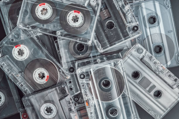 a stack of audio tape cassettes on black background. - stack rock audio foto e immagini stock