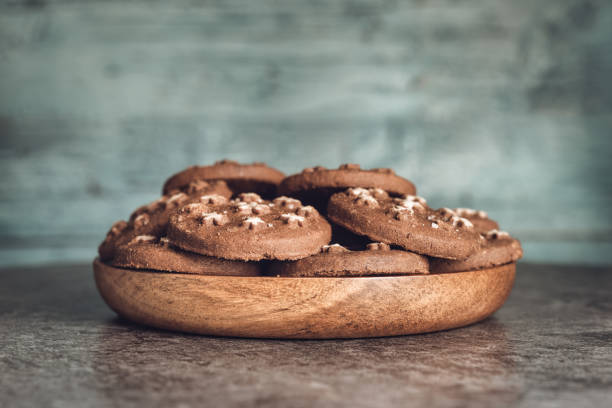 delicious sweet cocoa cookies biscuits on a wooden plate - 11310 fotografías e imágenes de stock