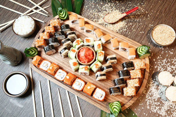 istock Wooden Tray Topped With Assorted Sushi Rolls and Nigiri 1985803395