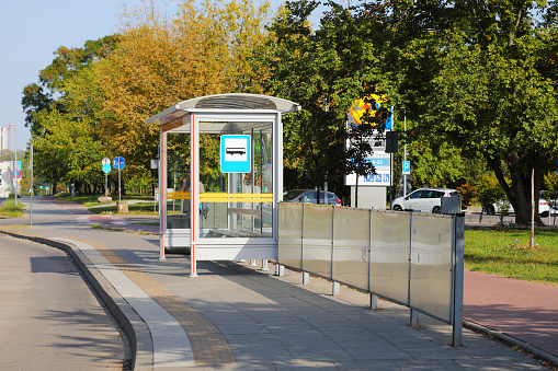 Warsaw, Poland - September 10, 2023: The bus stop is located on the city streets in the Goclaw housing estate. There are trees behind the bus stop.