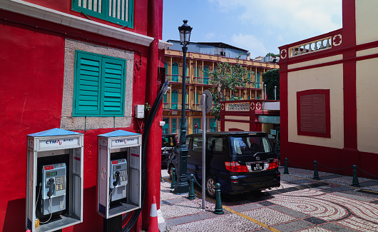 Macao, China - May 12, 2023: A vibrant red building on a street in Macau.