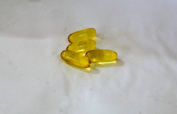 Soft gel fish oil capsules in white background.