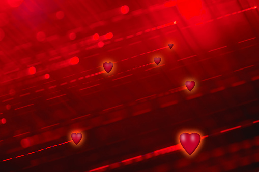 Red defocused lines background with glowing hearts. Can be used as a design for romantic or Valentine's day holiday greeting cards or posters.