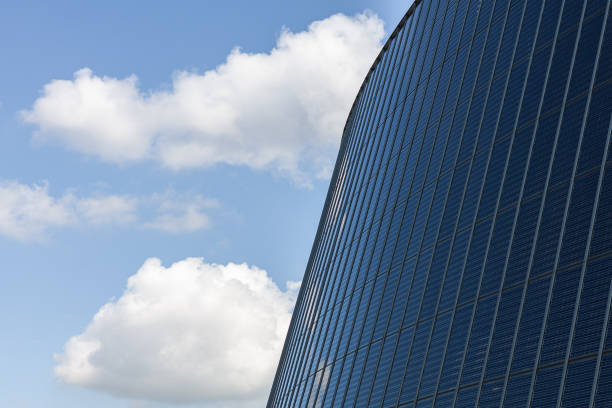 istock Modern office building with blue sky and white clouds. Business background. 1985914510