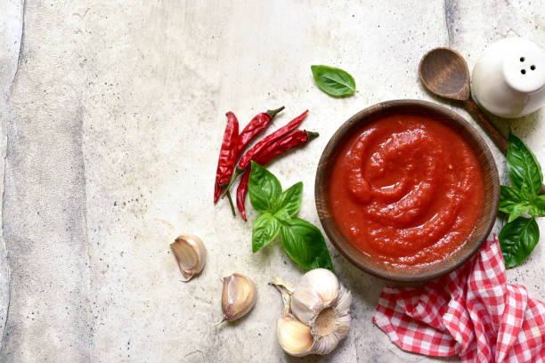 istock Homemade spicy tomato sauce with ingredients for making. Top view with copy space. 1985930795