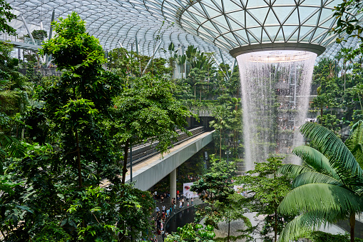 Singapore, Singapore - September 03, 2023: visitors tours the Rain Vortex, an artificial waterfall at Jewel Changi Airport. Singapore.