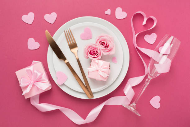 istock Festive table setting for Valentine's Day on color background, top view 1986000220