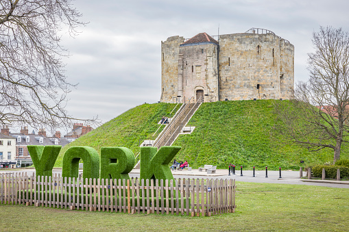 YORK, UK - April 16, 2023. York sign outside the motte and bailey of Cliffords Tower, York castle museum, York, UK