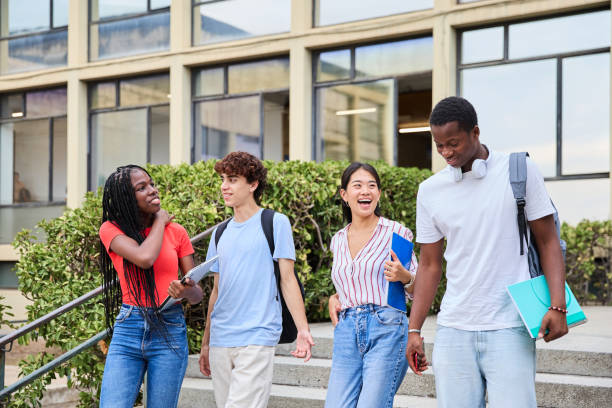 istock Cheerful multiethnic students walking down the stairs on the college campus 1986004408