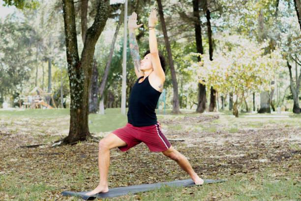 istock a young man practicing yoga in the middle of nature 1986019951