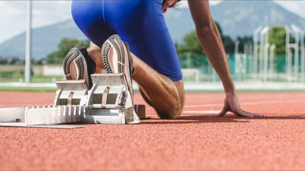 istock Male hands on the run starting line, ready, set and go 1986036644