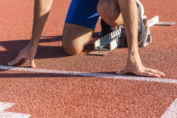 istock Male hands on the run starting line, ready, set and go 1986042465