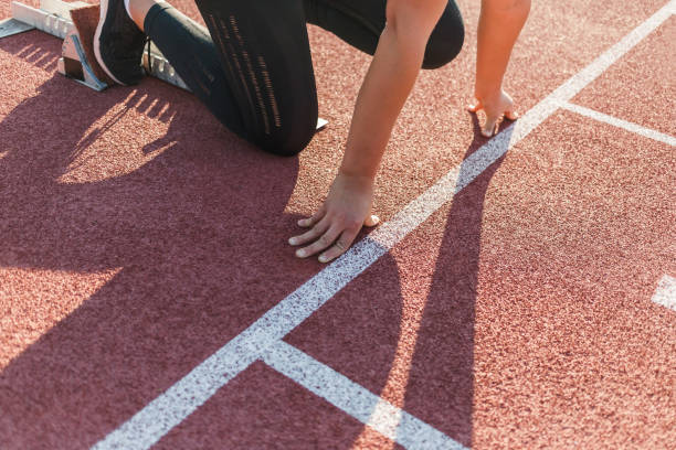 istock Woman at the athletic starting point, ready steady and go 1986042981