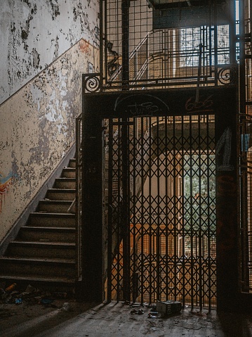 An old elevator and staircase in an abandoned hospital located in France