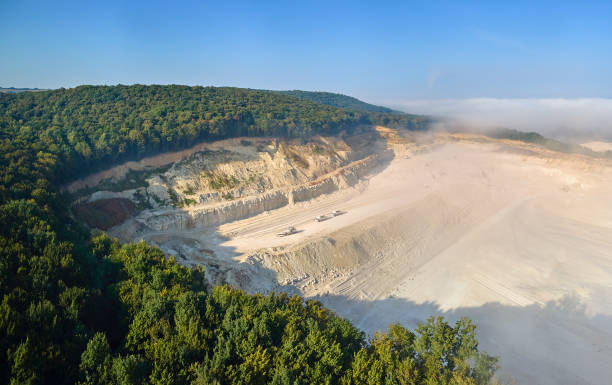 istock Aerial view of open pit mining site of limestone materials extraction for construction industry with excavators and dump trucks. 1986087148