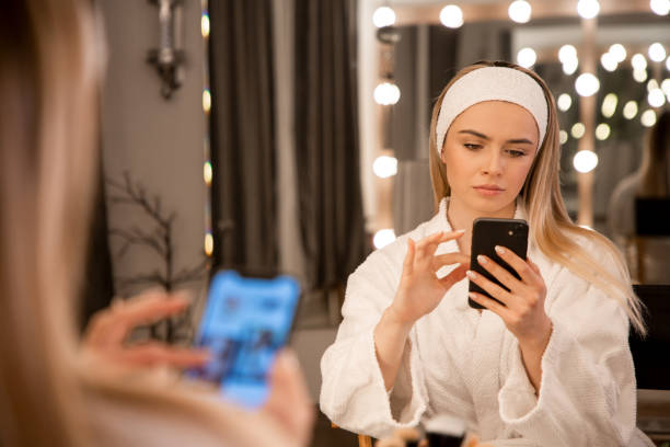 Creative Oasis: Makeup Artist Finds Inspiration on Phone stock photo