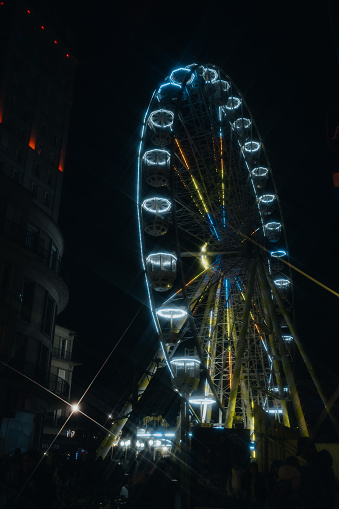 A ferris wheel at night in the city center of Amiens, France
