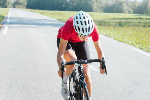 istock Female bicyclist changing a body position during a race, front view 1986143669