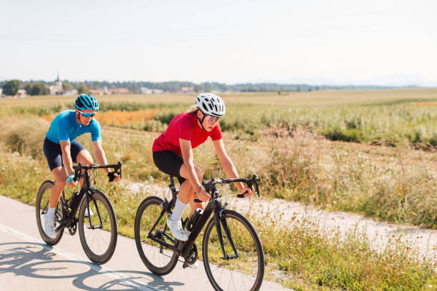 istock Two road racing cyclists riding one after another 1986152553