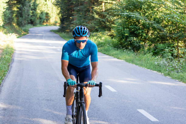 istock Racing cyclist riding uphill on an open road cycling route 1986170521