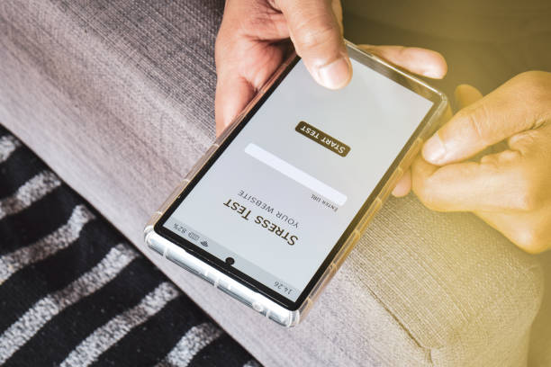 istock Person using smartphone mobile applications to check stress test or load test his website. Concept, selective focus. 1986186154