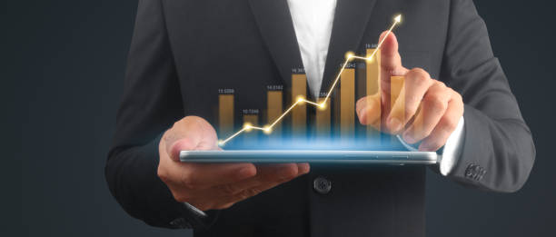 istock Businessman plan graph growth and increase of chart positive indicators,tablet in hand 1986187212