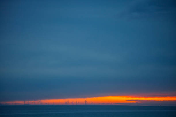 South Padre Island sunset with wind turbines in the distance. Texas, USA
