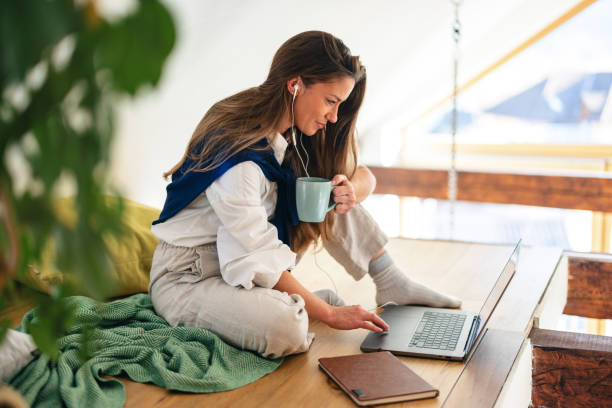 istock Woman Enjoying Coffee While Working on Laptop at Home 1986194495