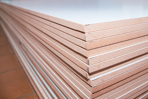 stack of MDF panels close-up at furniture production