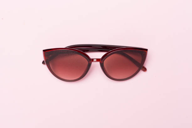 istock Sunglasses on color background, top view. 1986199248