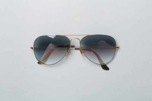 Vintage cat eye sunglasses featuring a tortoiseshell pattern resting on a striped background