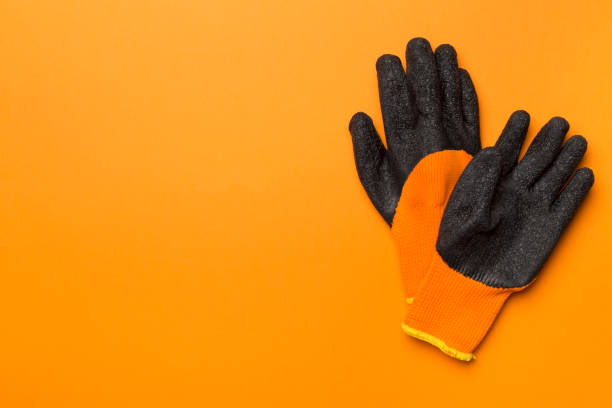 istock Garden gloves on color background, top view 1986219915
