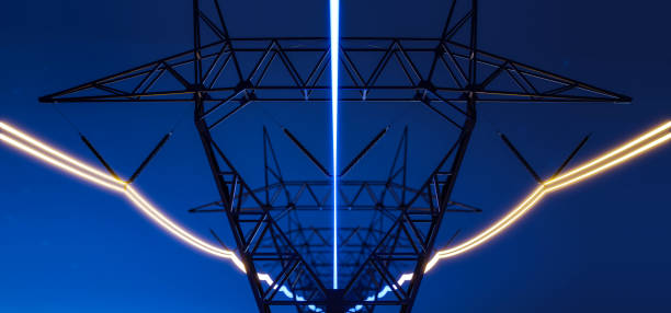 istock High voltage electric transmission tower with glowing current line 1986221479
