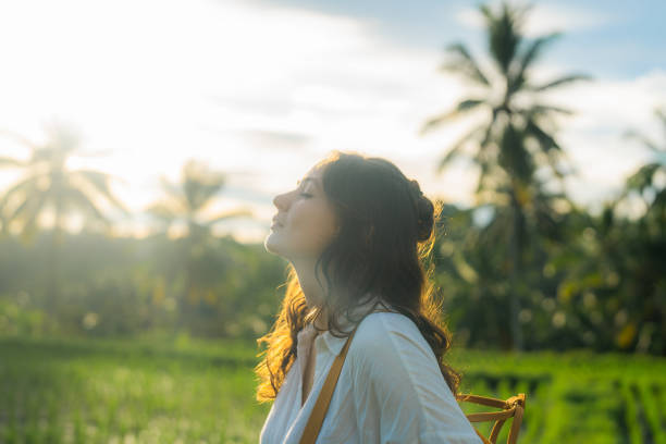 istock Cheerful woman walking on rice paddy on Bali 1986265200
