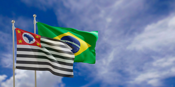 Official flags of the country Brazil and federal state of Sao Paulo. Swaying in the wind under the blue sky. 3d rendering