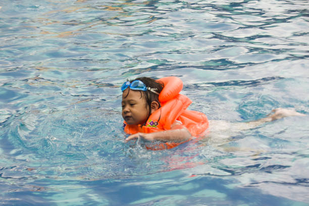 istock Swim using life jackets and swimming goggles 1986426986